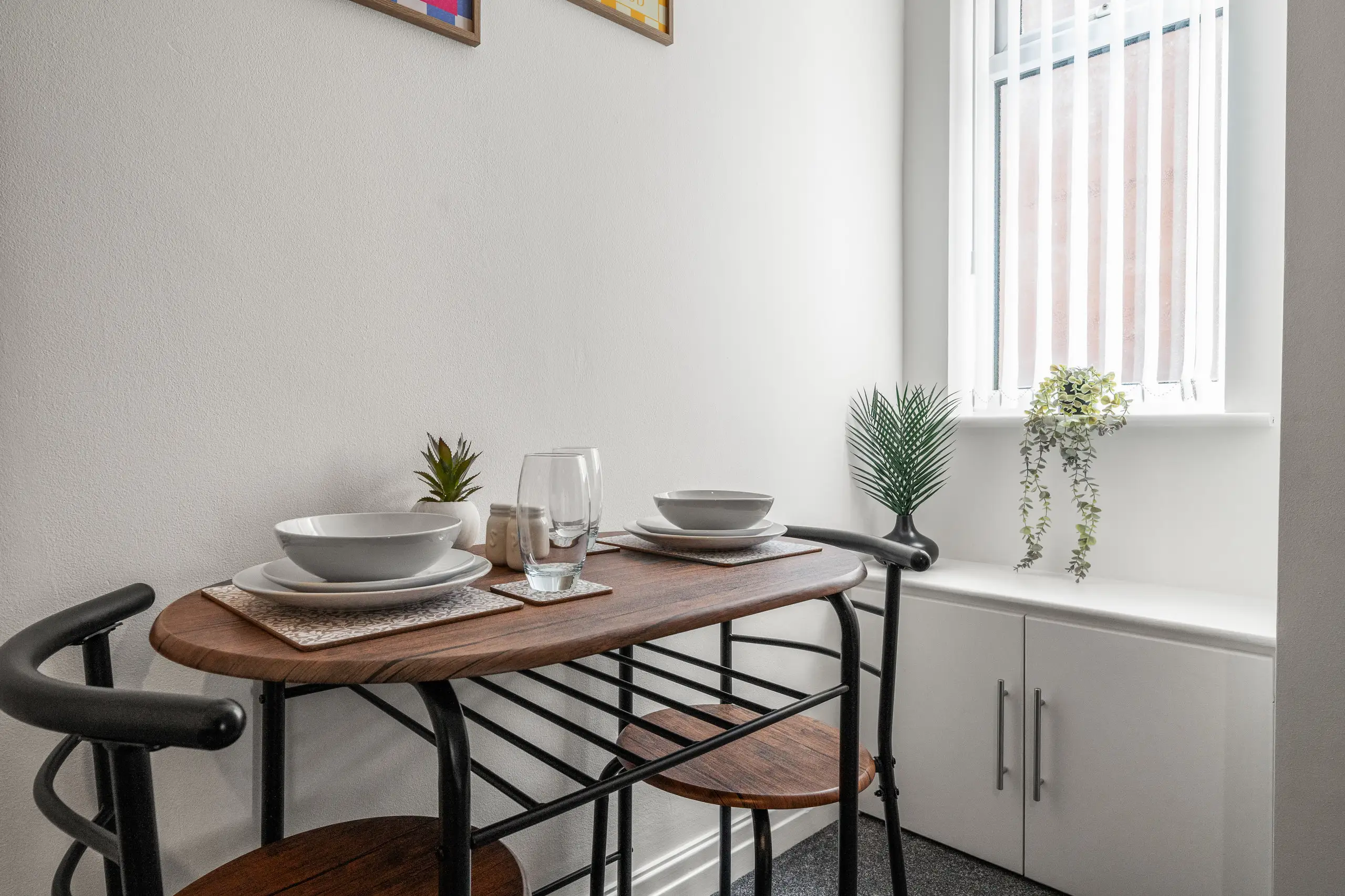 Small dining table for two beside a window